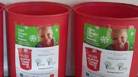 Red Barrels for food donation collection at Firefly Spa San Diego.
