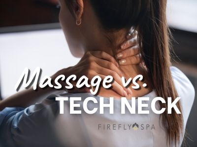 Woman experiencing tech neck at her computer. Considering massage at Firefly Spa.